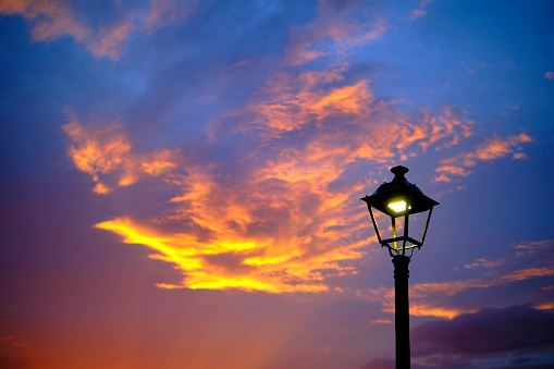 streetlight and sky with clouds at sunset