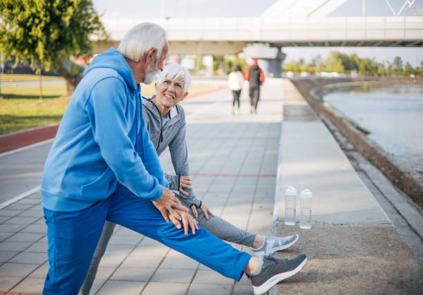 istock Senior couple stretch out in nature before running 2150266897