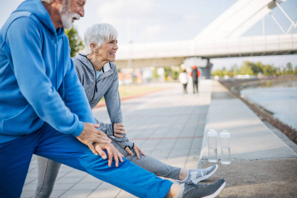 istock Senior couple stretch out in nature before running 2150266904