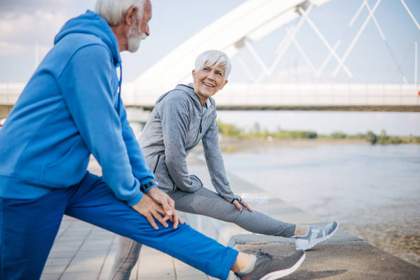 istock Senior couple stretch out in nature before running 2150266905