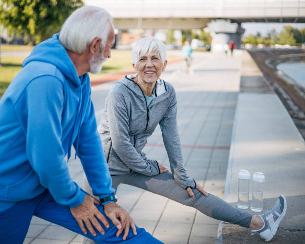 istock Senior couple stretch out in nature before running 2150267208