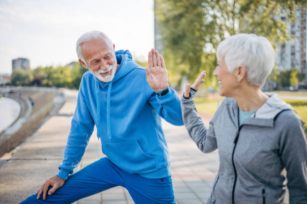 istock Senior couple stretch out in nature before running 2150267297