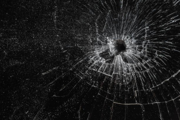 istock Bullet hole in a glass on the black background.closeup. 2150268374