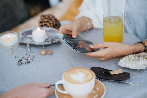 Female hands are holding tarot cards and preparing to make a layout