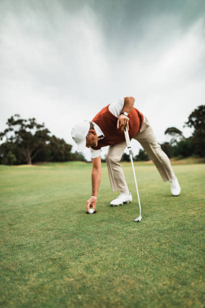 istock Removing the golf ball from the hole 2150271331