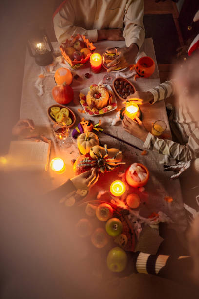 istock Above view of unrecognizable family at dining table on Halloween. 2150271375