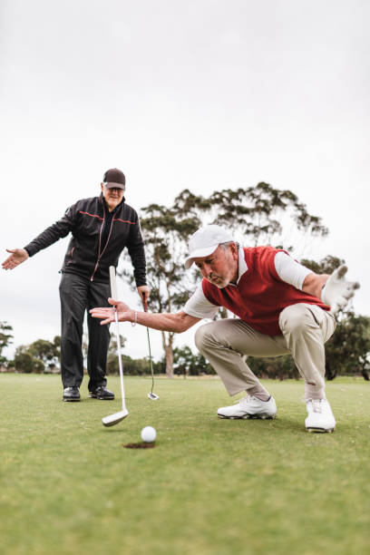 istock Removing the golf ball from the hole 2150271553