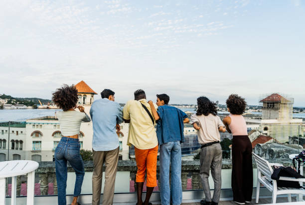 istock Friends talking and looking away on the rooftop 2150272466