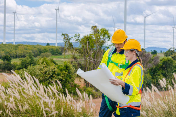 istock Engineer team working group survey at wind turbine clean power generator service maintenance wind mill outdoor. 2150272865
