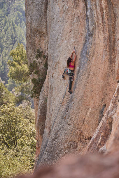 istock Faceless alpinist climbing rocky mountain 2150275709