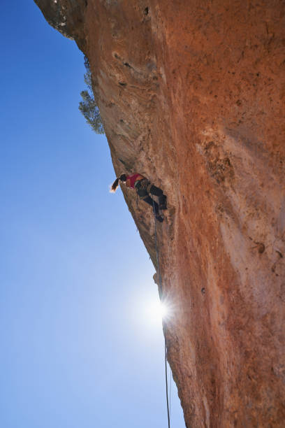istock Unrecognizable woman climbing steep cliff 2150275735