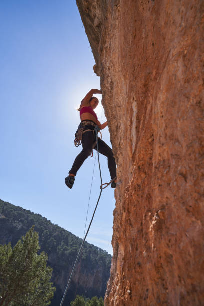 istock Female alpinist hanging off cliff 2150275778