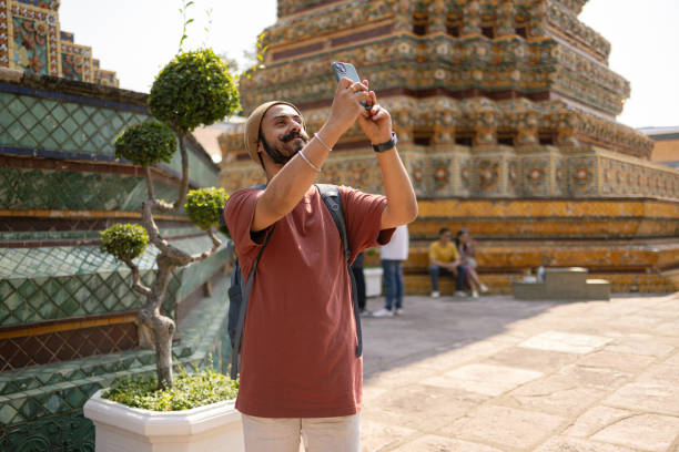 istock Smiling Indian man photographing ancient architecture. 2150276213