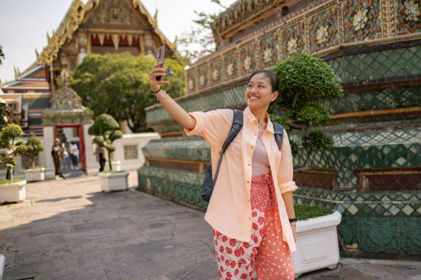 istock Happy Thai woman taking a selfie by the ancient architecture. 2150276371
