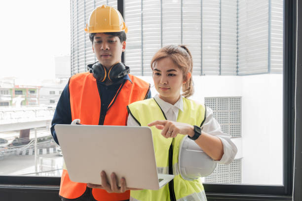istock The female foreman discusses with the engineering team about the construction project plans and plans. 2150276571