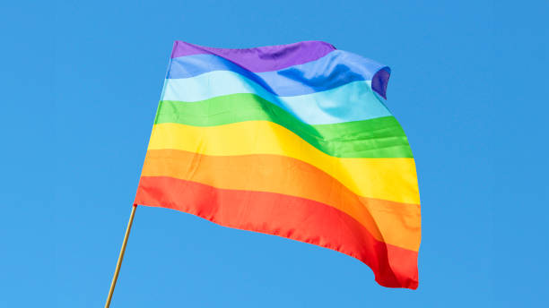 istock LGBT flag on in front of pretty blue sky 2150278029