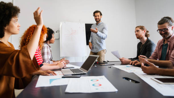 istock Diverse group of happy employees analyzing reports with digital device, working together in office 2150278706