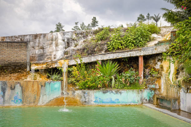 Sipoholon, Thermal Springs, North Sumatra, Indonesia - February 2nd 2024:  Old thermal pool in tropical lush surroundings