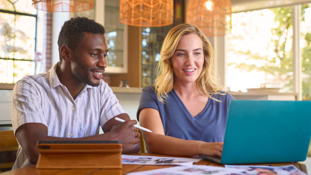 istock Couple Working From Home In Design Publishing Or Creative Industry With Digital Tablet With Stylus 2150282113