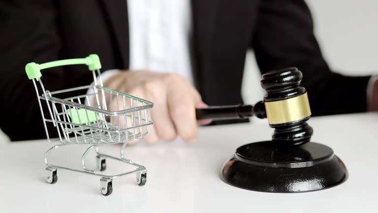 Consumer Rights Act. Male Judge hitting Gavel off a block in courtroom. Shopping trolley on the table.