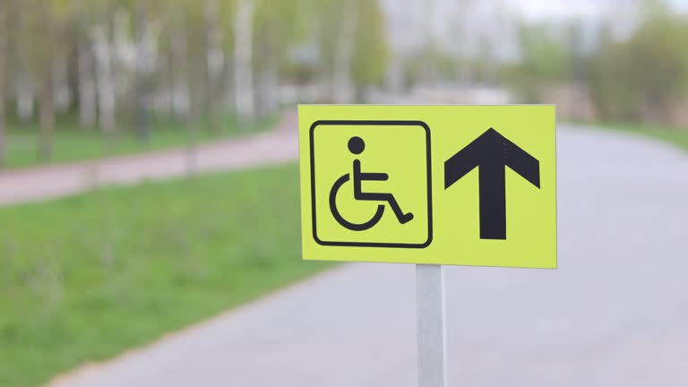 Accessible disabled sign at city park. Inclusivity, equal rights, and consideration for individuals with disabilities.