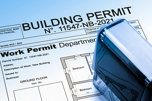Buildings Permit concept with residential building project and plastic stamp