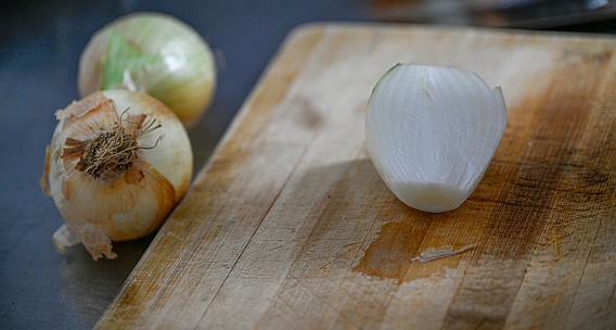 Chopped onion on a cutting board close-up - preparation for cooking a dish with onions