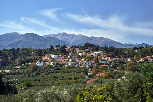 A town in the valley and rocky peaks in the Lefka Ori mountains on the island of Crete, Greece