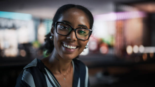 istock Portrait of Successful Black Businesswoman Using Desktop Computer, Analysing Data, Thinking and Solving Problems. Female Manager Looking At Camera And Smiling In Creative Agency Modern Office 2150286688