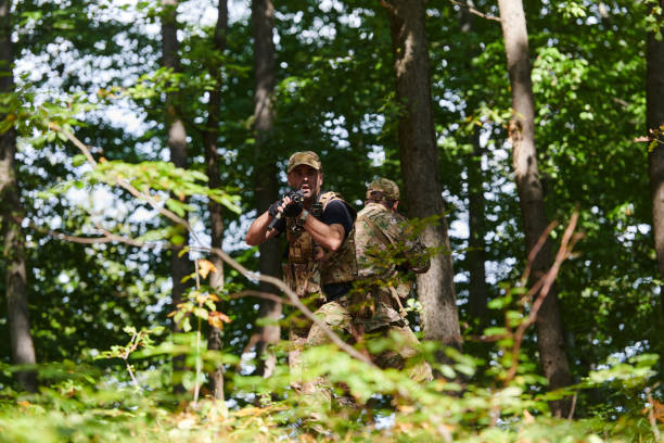 istock A specialized military antiterrorist unit conducts a covert operation in dense, hazardous woodland, demonstrating precision, discipline, and strategic readiness 2150287627