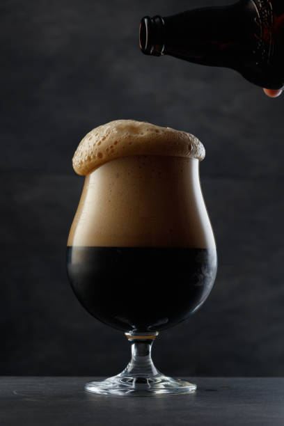 istock Dark beer with overflowing foam head. 2150289114