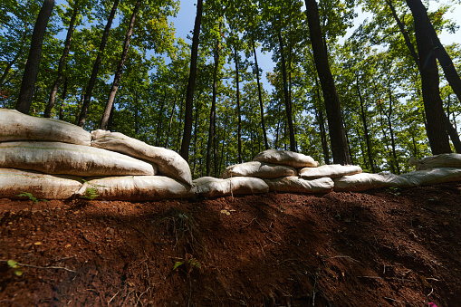 a military unit strategically employs sandbags as a defensive wall, creating a fortified barrier to enhance their safety and protection, showcasing the tactical use of simple yet effective measures in their encampment