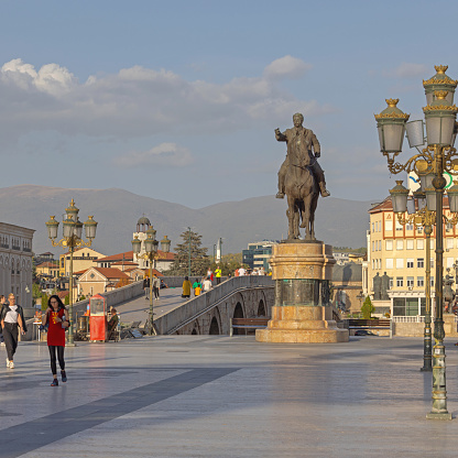 Skopje, North Macedonia - October 23, 2023: Equestrian Statue Monument Goce Delcev and Stone Bridge at Capital City Central Square Sunny Afternoon.
