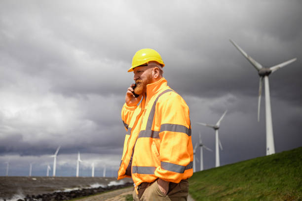 Engineer mechanic in a windmill farm park.