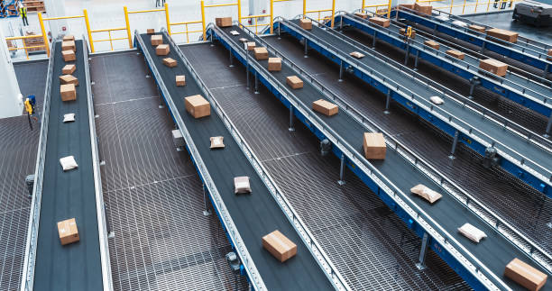 istock High Angle with Parcels, Boxes and Packages Moving on a Conveyor Line in a Modern Logistics Center with Autonomous Sorting Technology. Online Shopping Orders Efficiently Prepared for Delivery 2150292341