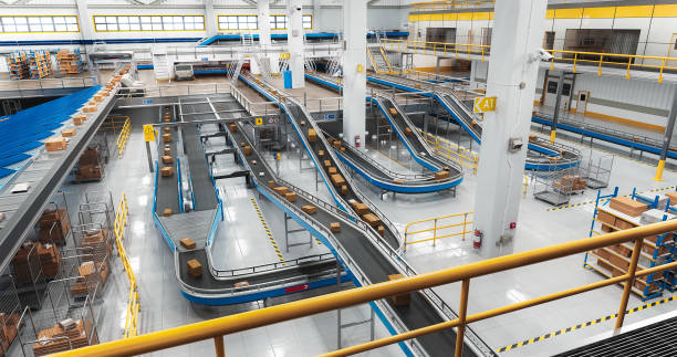 istock Modern Delivery Logistics Warehouse with Working Automated Conveyor Belt with Retail Parcels, Cardboard Boxes and Online Shopping Orders Being Prepared for Shipping 2150292434