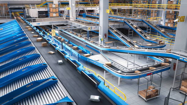 istock Modern Delivery Logistics Warehouse with Working Automated Conveyor Belt with Retail Parcels, Cardboard Boxes and Online Shopping Orders Being Prepared for Shipping 2150292515