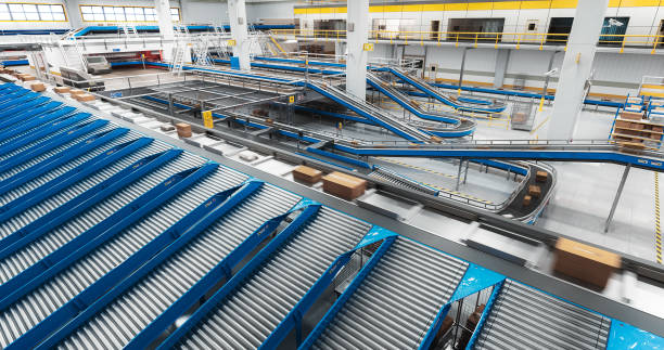 istock Parcels, Cardboard Boxes and Packages Lying on a Conveyor Belt at a Modern Logistics Center with Automated Sorting Technology. VFX 3D Graphics in a Mail Delivery Warehouse Hub 2150292540