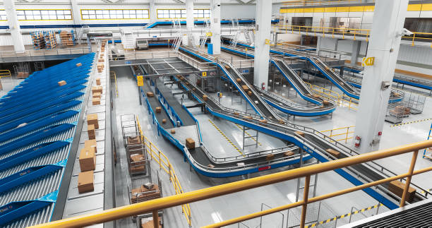istock Parcels, Cardboard Boxes and Packages Lying on a Conveyor Belt at a Modern Logistics Center with Automated Sorting Technology. VFX 3D Graphics in a Mail Delivery Warehouse Hub 2150292555