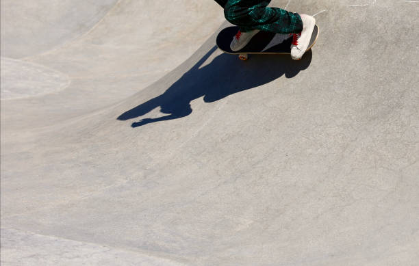 istock Athletic skateboarder shadow on the skate park wall 2150292614