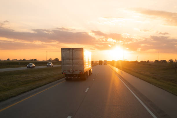 Sunset Hues Casting Golden Light on a Freeway with Moving Truck