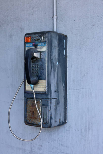 istock Coin operated pay phone hanging on the wall 2150292844