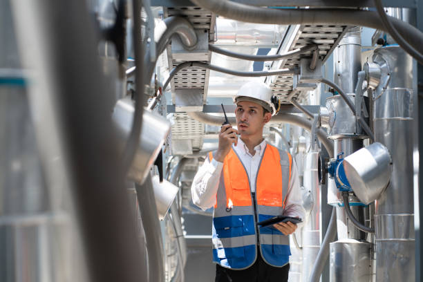 istock Engineers are inspecting a large building or industrial facility's cooling system for the air conditioning on rooftop building. 2150296436