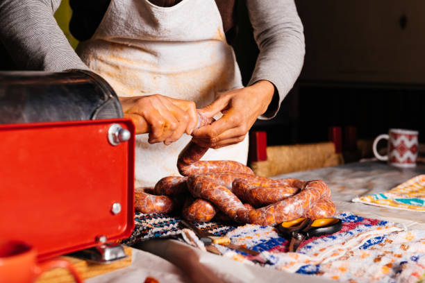 istock Crop female butcher making chorizo with machine 2150297729