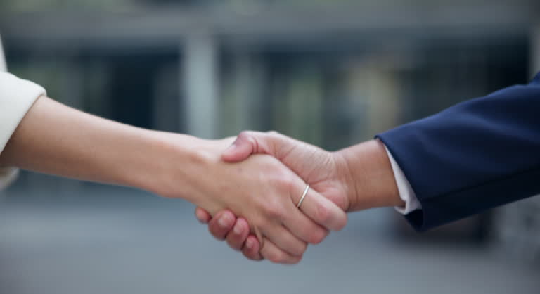 Handshake, interview or business people in city closeup for hiring meeting, welcome or startup deal negotiation. Zoom, thank you or team shaking hands in b2b support, collaboration or crm partnership