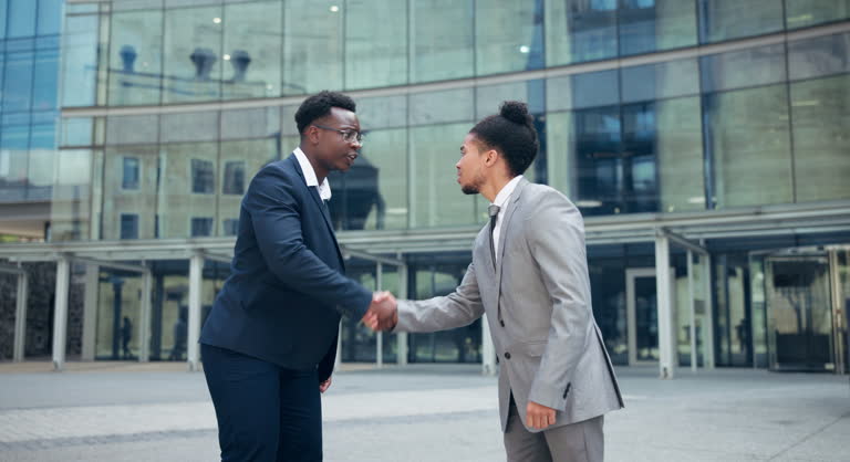 Welcome, handshake and business men in city meeting for partnership, collaboration or support. Contract, deal and people outdoor shaking hands, consulting or b2b networking, onboarding or negotiation