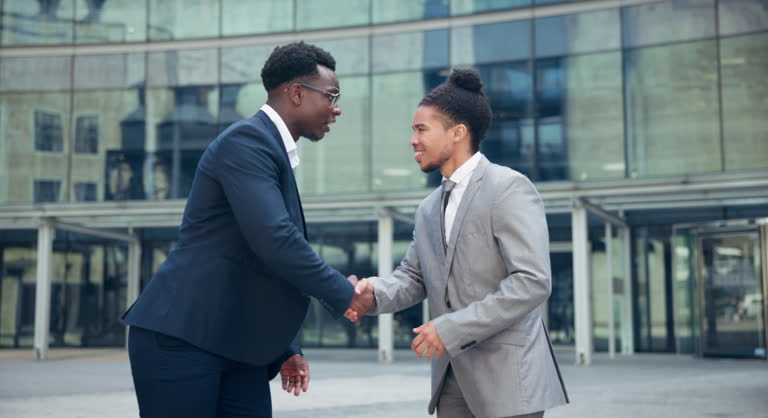 Handshake, welcome and business men in city meeting for partnership, collaboration or support. Contract, deal and people outdoor shaking hands, consulting or b2b networking, onboarding or negotiation