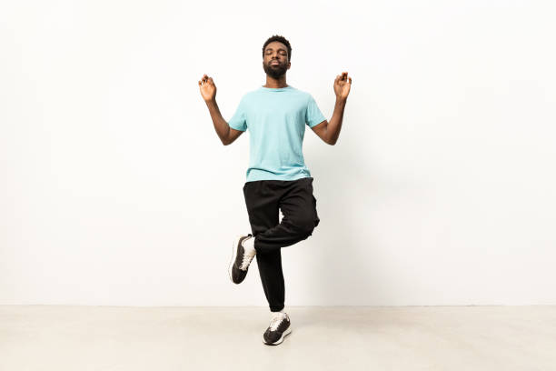 istock Young Man Meditating in Yoga Pose on White Background 2150299844