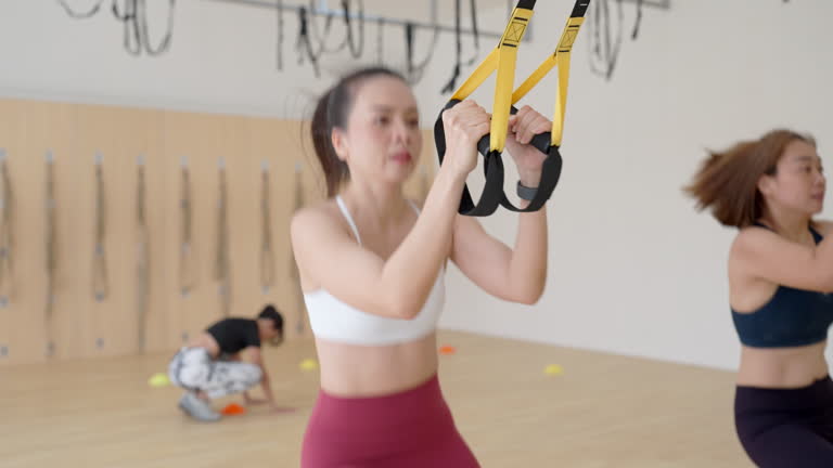 Two women are exercising with resistance bands
