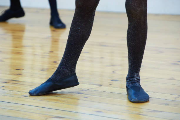 istock Step into Focus: Legs in Tights on Hardwood Floor 2150300923